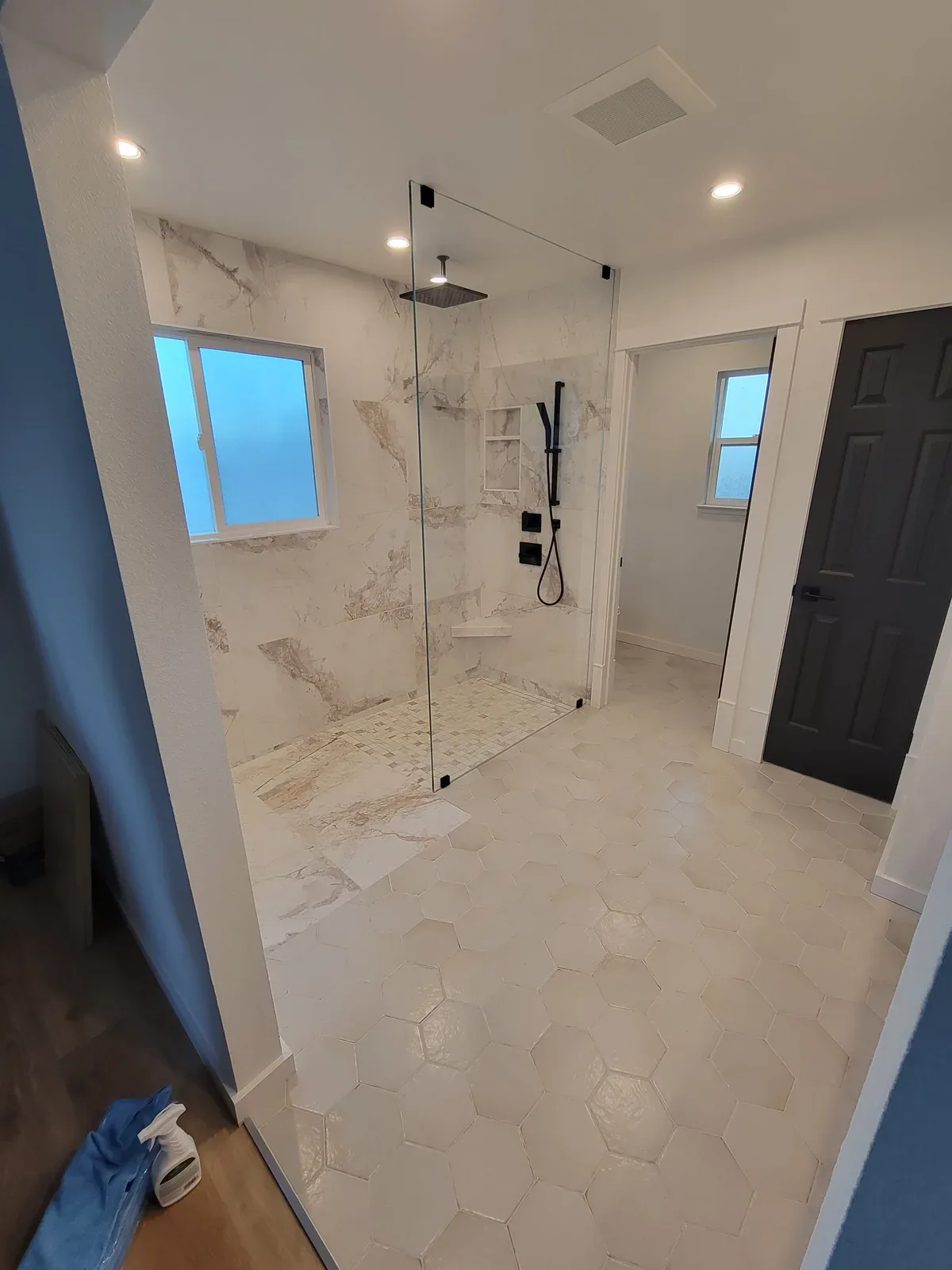 bathroom shower remodel with dark accent tile