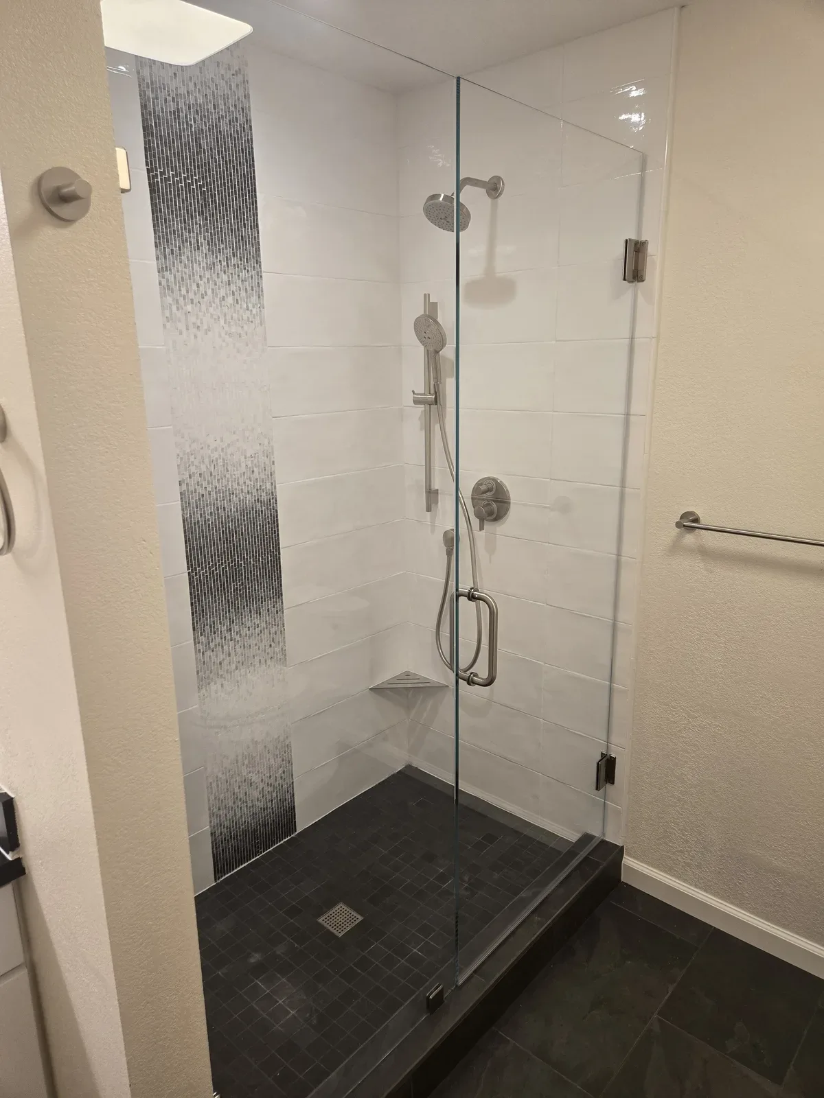 bathroom remodel with black tile shower floor