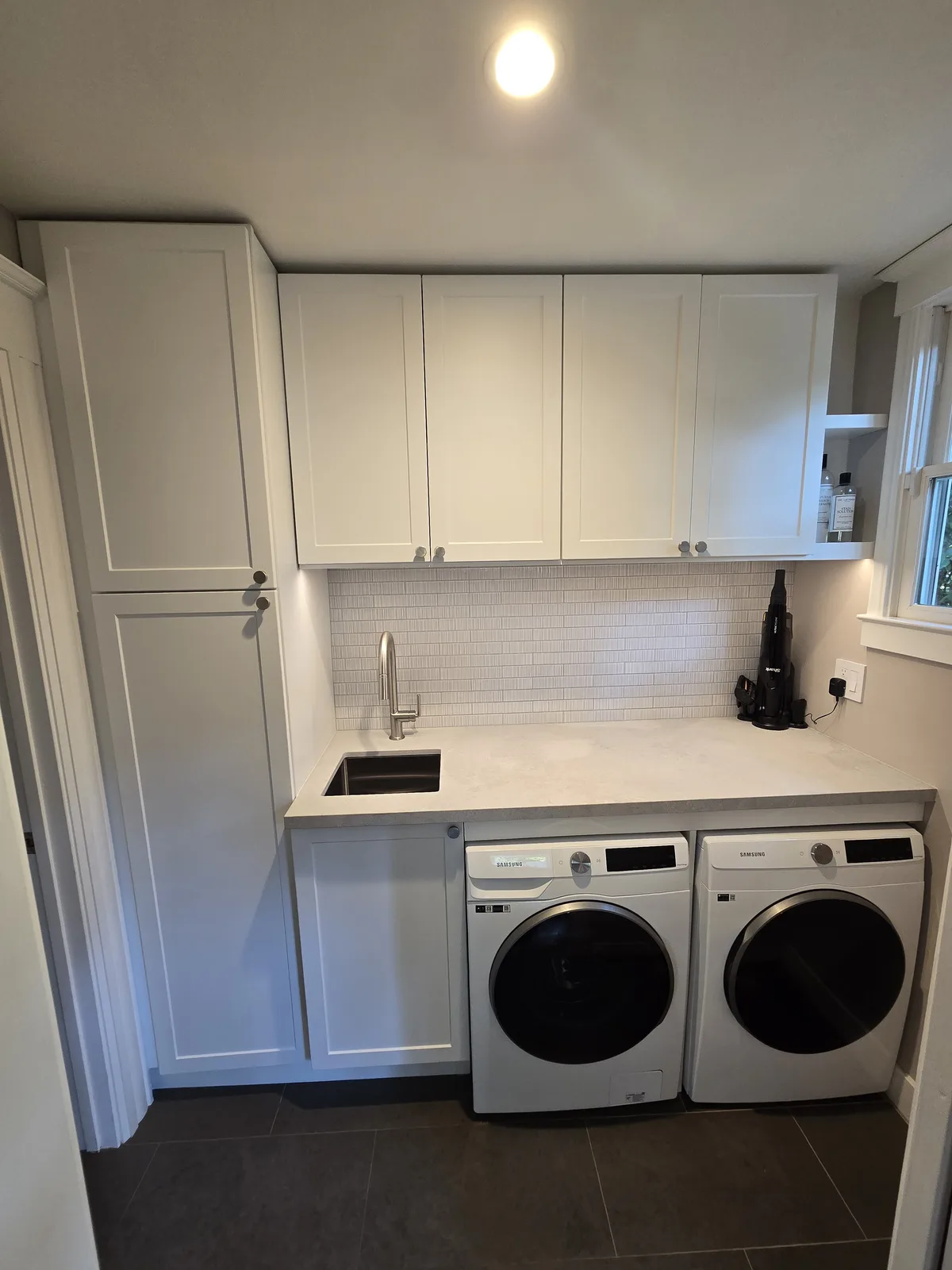 laundry room renovation with washer and dryer cabinets